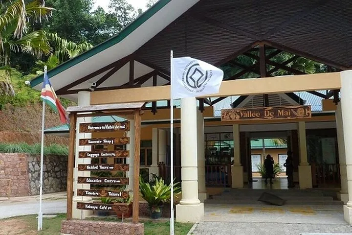 Entrance building to Vallee de Mai nature reserve with signs