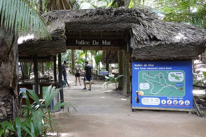 Entrance gate to Vallee de Mai with a large map sign